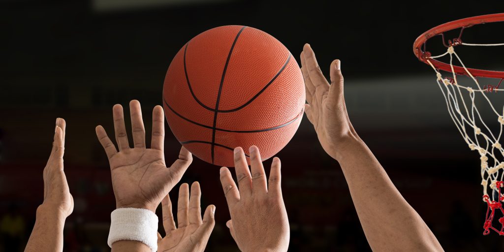 Basketball ball is flying with basketball hoop over a basketball